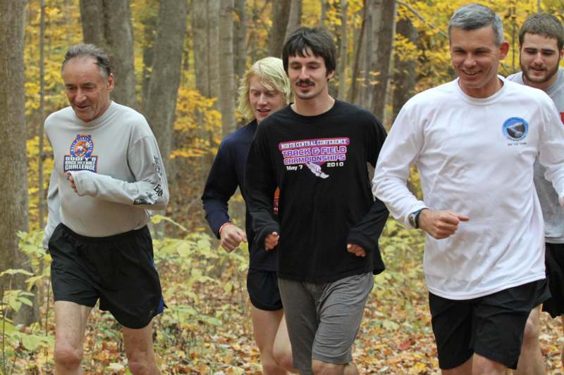 a group of men running in the woods