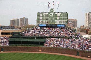 a crowd of people in a stadium with Wrigley Field in the background