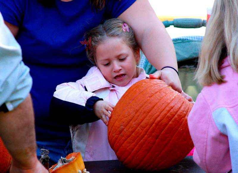 a girl holding a pumpkin