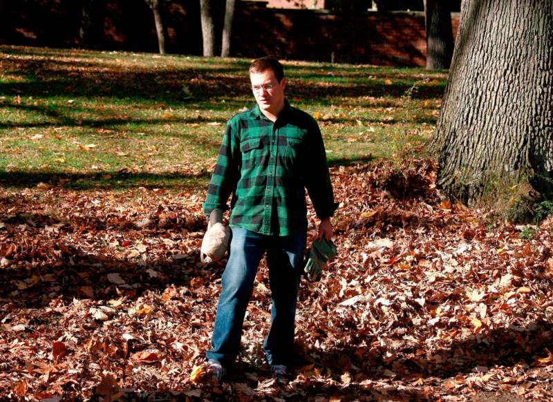 a man standing in the leaves