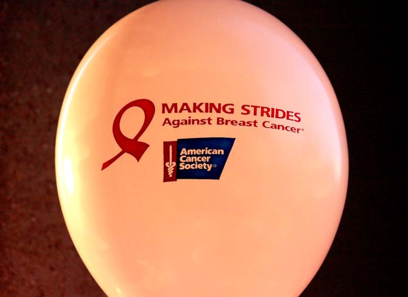 a balloon with a red ribbon and a blue logo