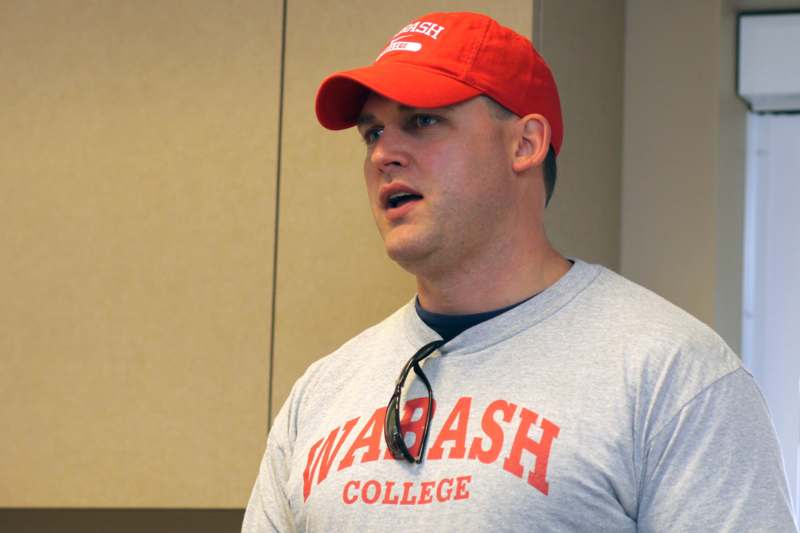 a man wearing a red hat and a grey shirt