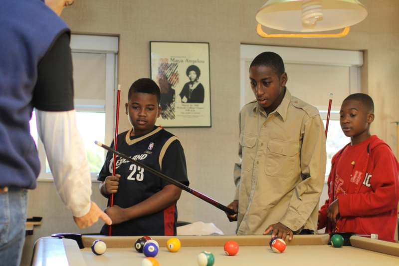 a group of kids playing pool
