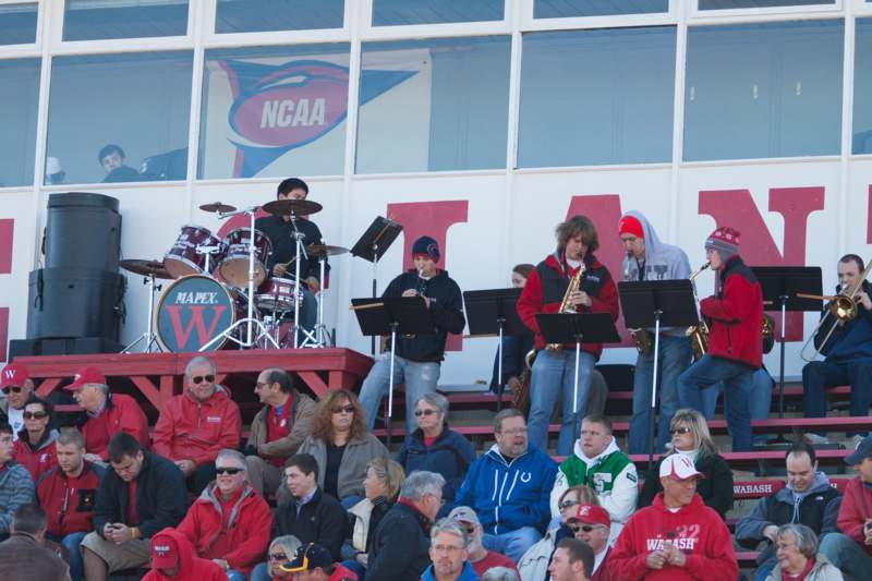 a group of people playing instruments in a stadium