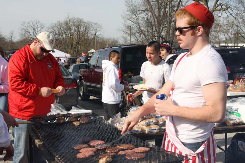 a group of people grilling burgers