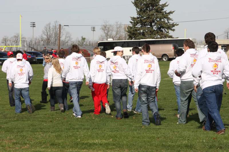 a group of people walking on a field