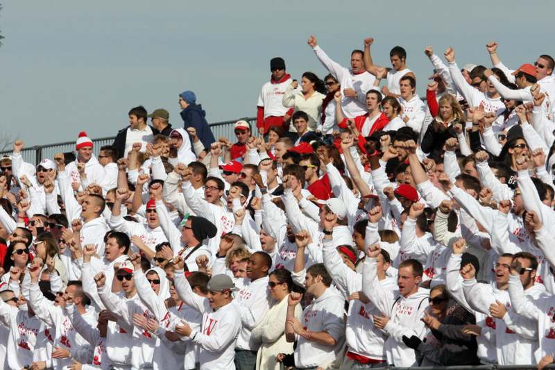 a large crowd of people in white shirts