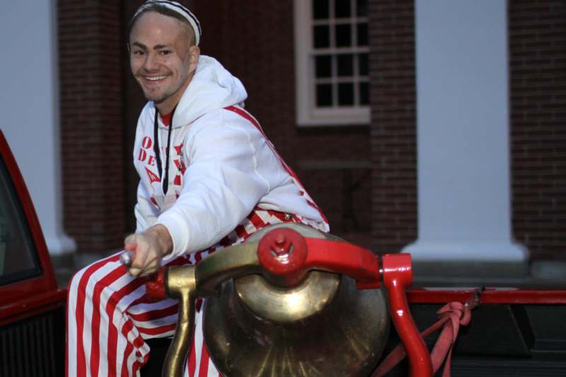 a man in a white and red striped outfit riding a cannon