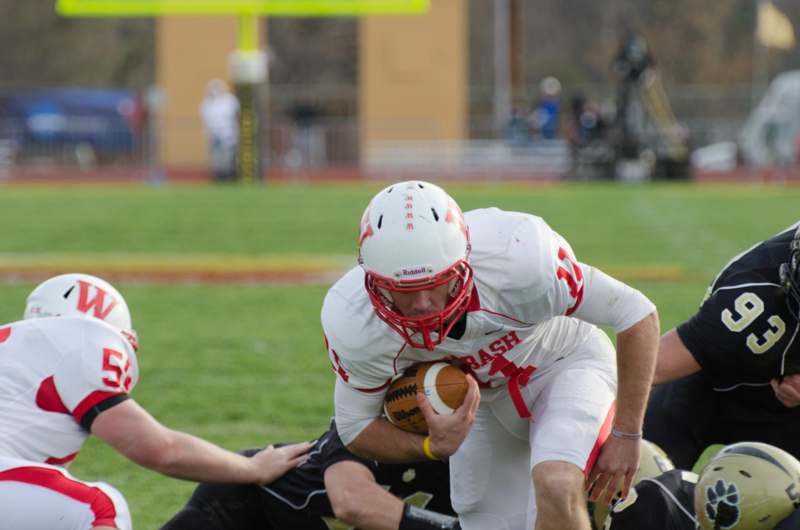 a football player in a white uniform holding a football