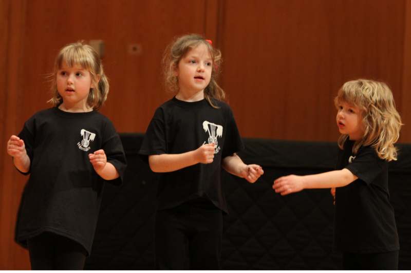 a group of children in black shirts