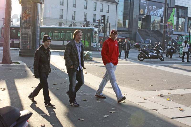 a group of men walking on a street