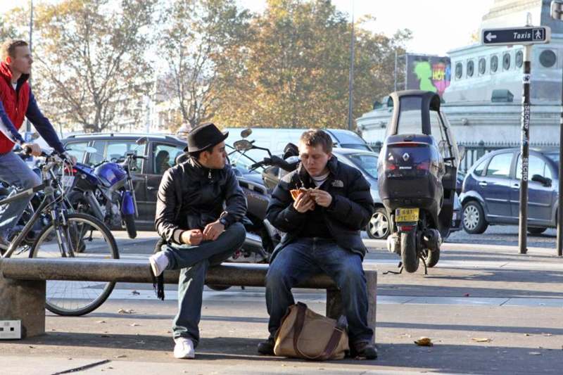 two men sitting on a bench