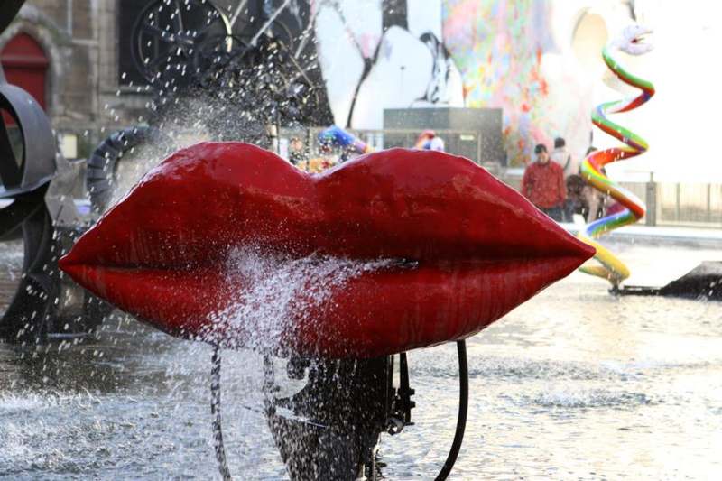 a water fountain with a large red lips