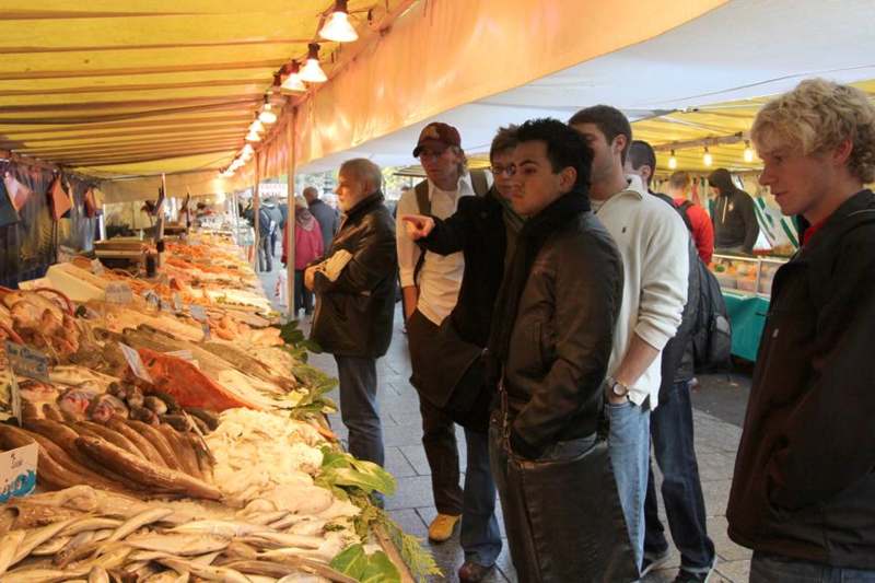 a group of people standing in a market