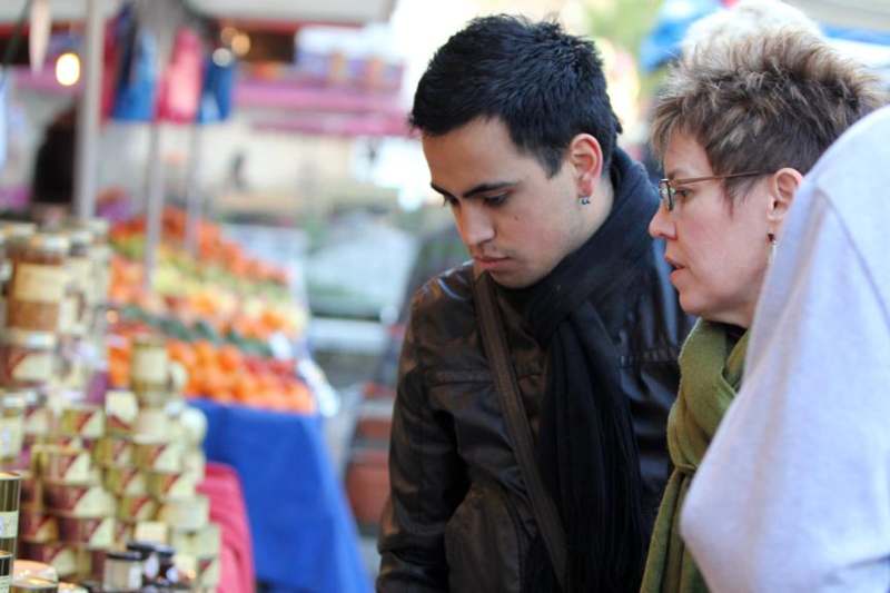 a man and woman looking at food