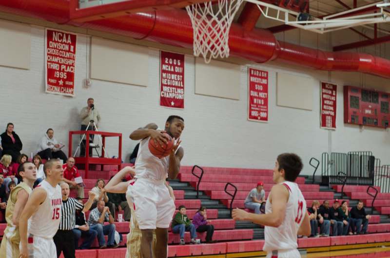 a man playing basketball in a gym