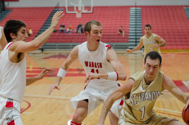 a group of men playing basketball