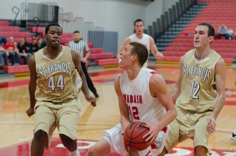 a group of men playing basketball
