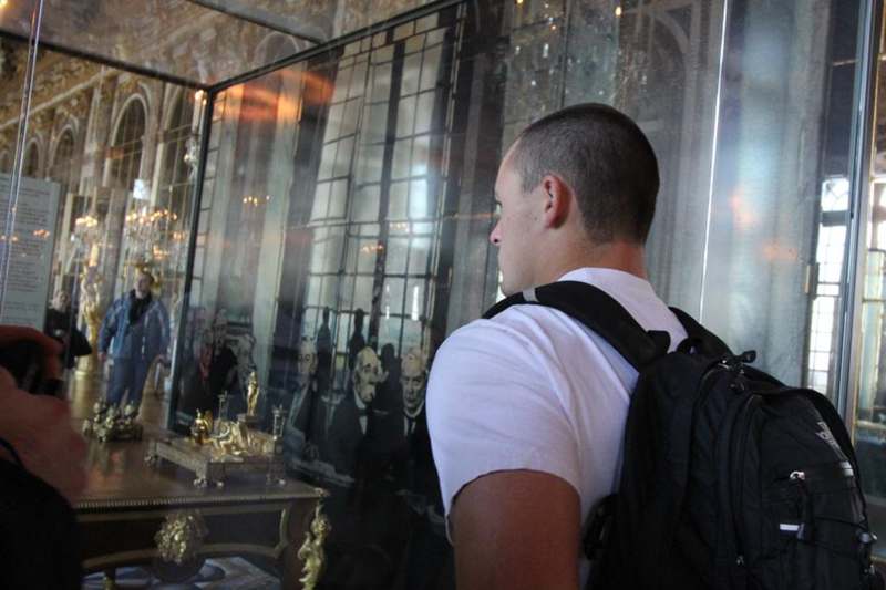a man looking at a glass display