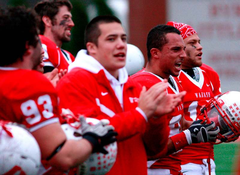 a group of football players clapping