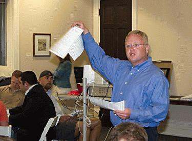 a man holding up papers