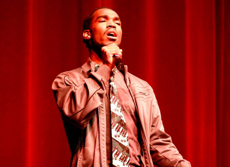a man singing into a microphone