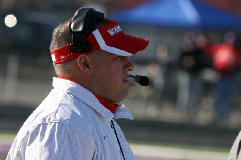 a man wearing a red visor and a microphone