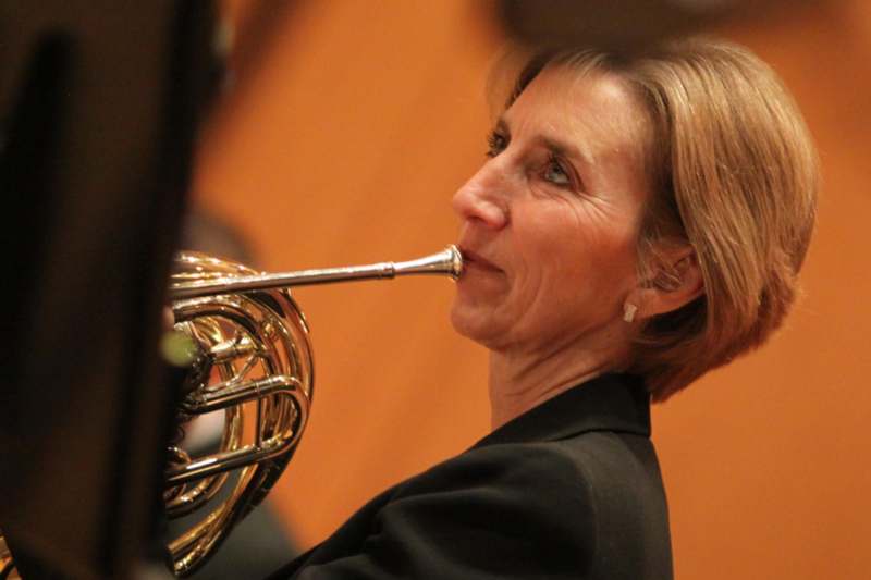 a woman playing a horn