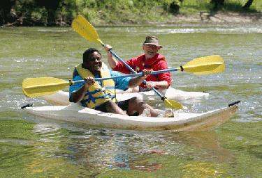 a couple of men paddling a kayak