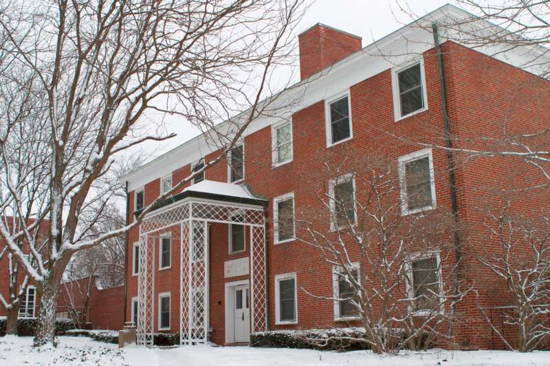 a brick building with snow on the ground