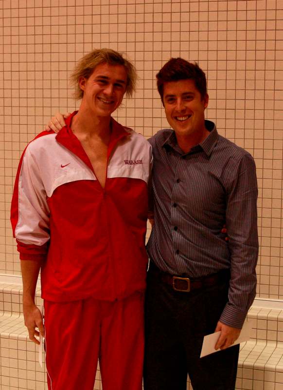 two men standing together in a swimming pool
