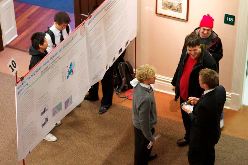 a group of people standing around a poster