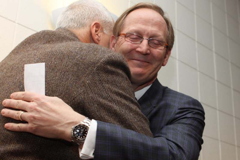 two men hugging each other