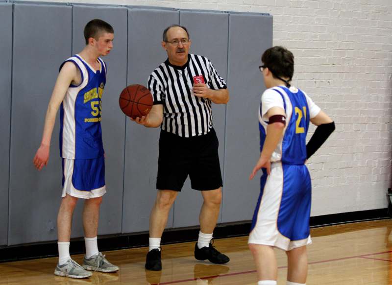 a basketball coach talking to a basketball player