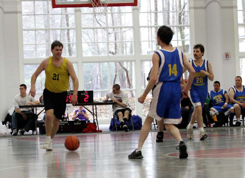 a group of men playing basketball