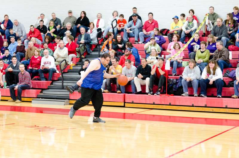 a man playing basketball in a gym