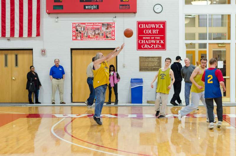 a group of people playing basketball