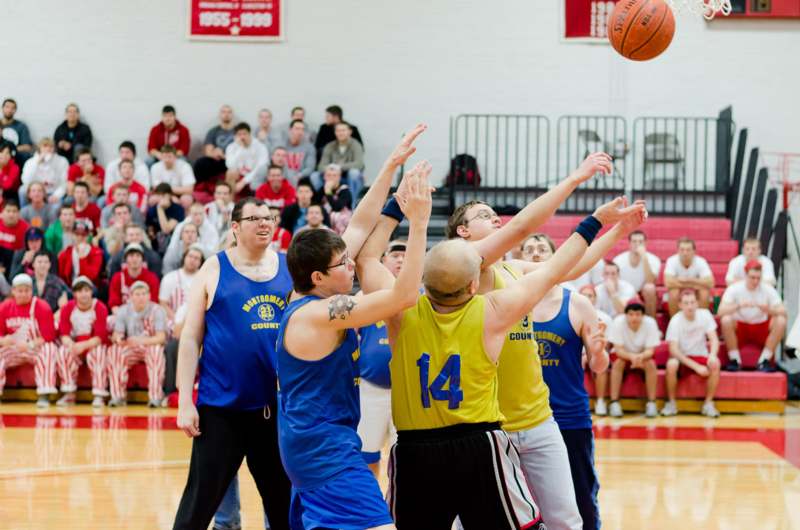 a group of men playing basketball