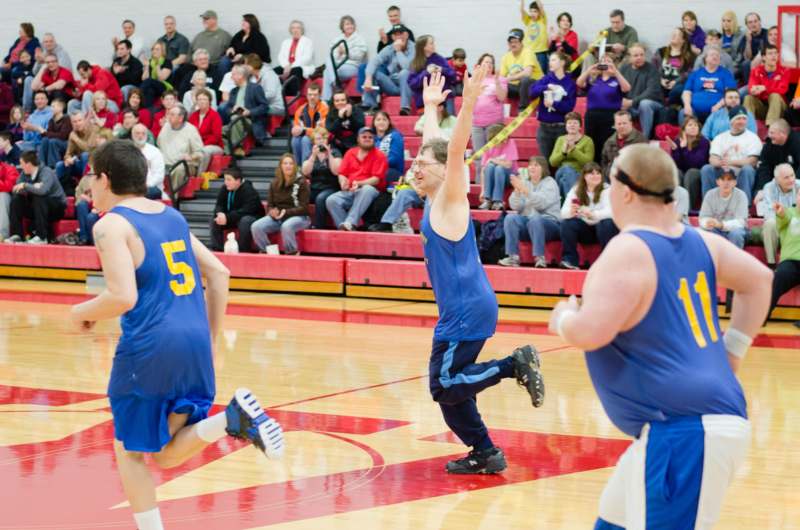 a group of men playing basketball