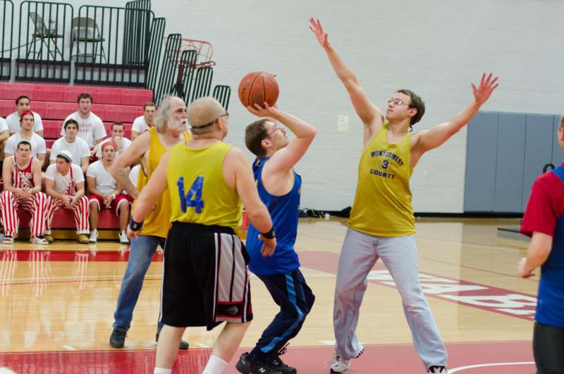 a group of men playing basketball
