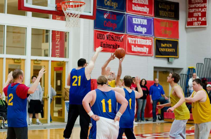 a group of men playing basketball