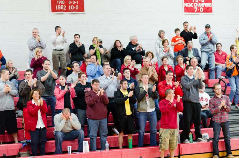 a group of people clapping in a gym