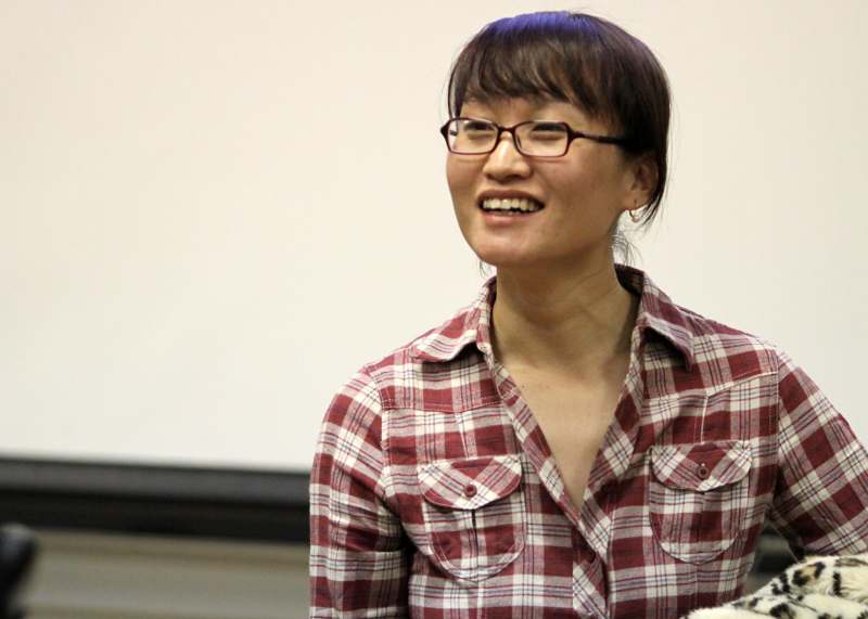 a woman wearing glasses and a plaid shirt