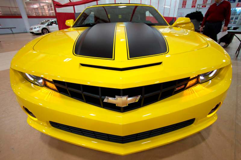 a yellow sports car with black stripes