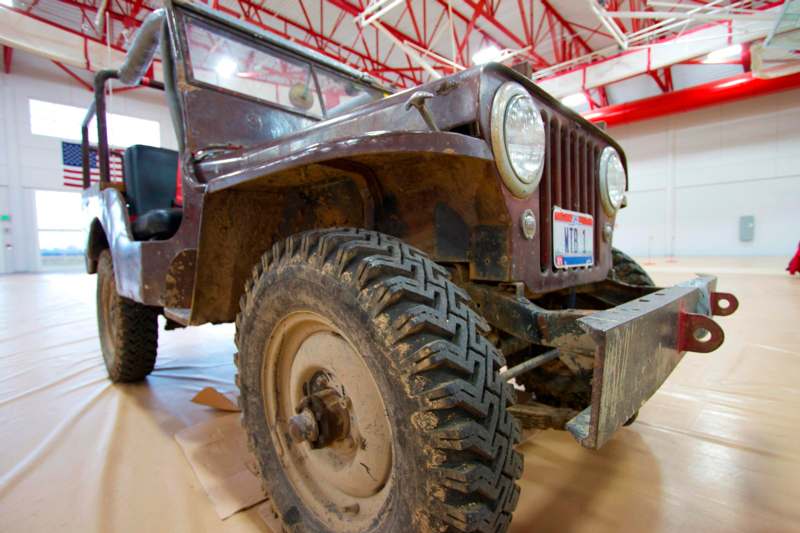 a dirty jeep in a large room