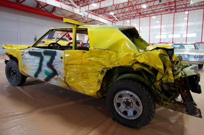 a yellow car with a damaged front end
