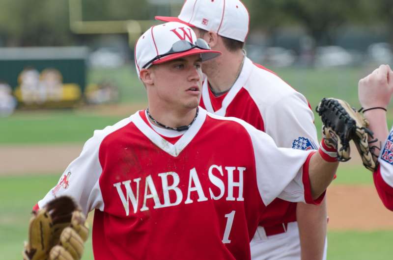 a baseball player in a red and white uniform