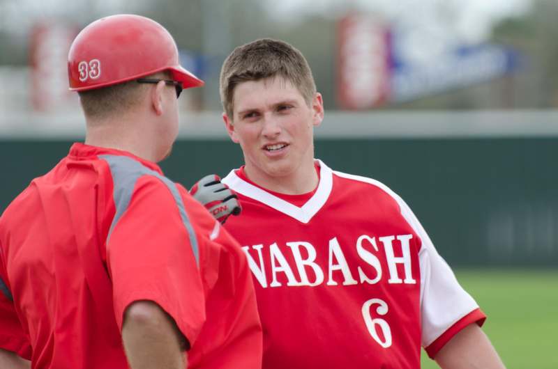 a baseball player talking to another baseball player