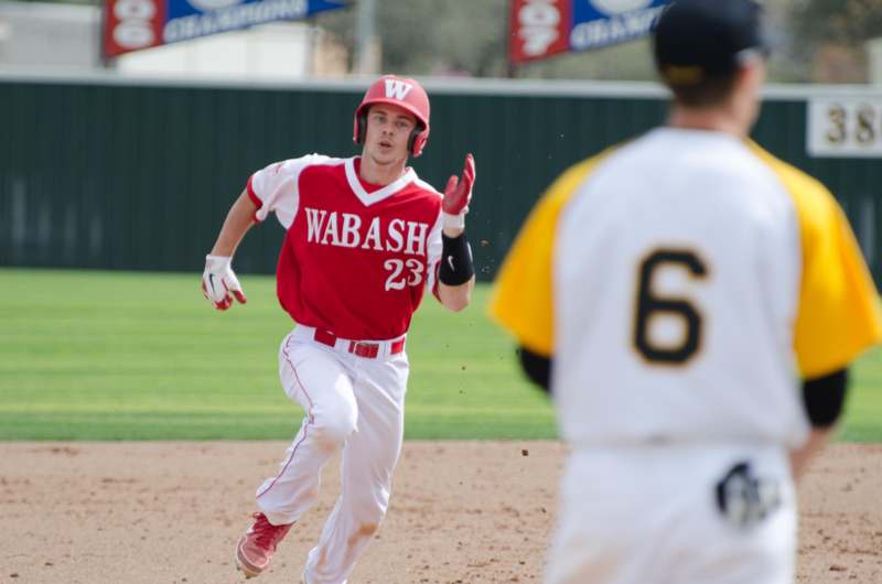 a baseball player running towards the base
