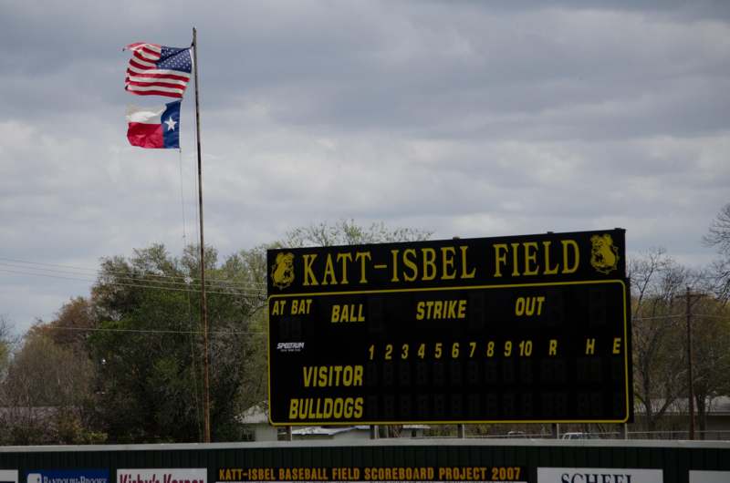 a scoreboard with a flag and a flag flying in the air